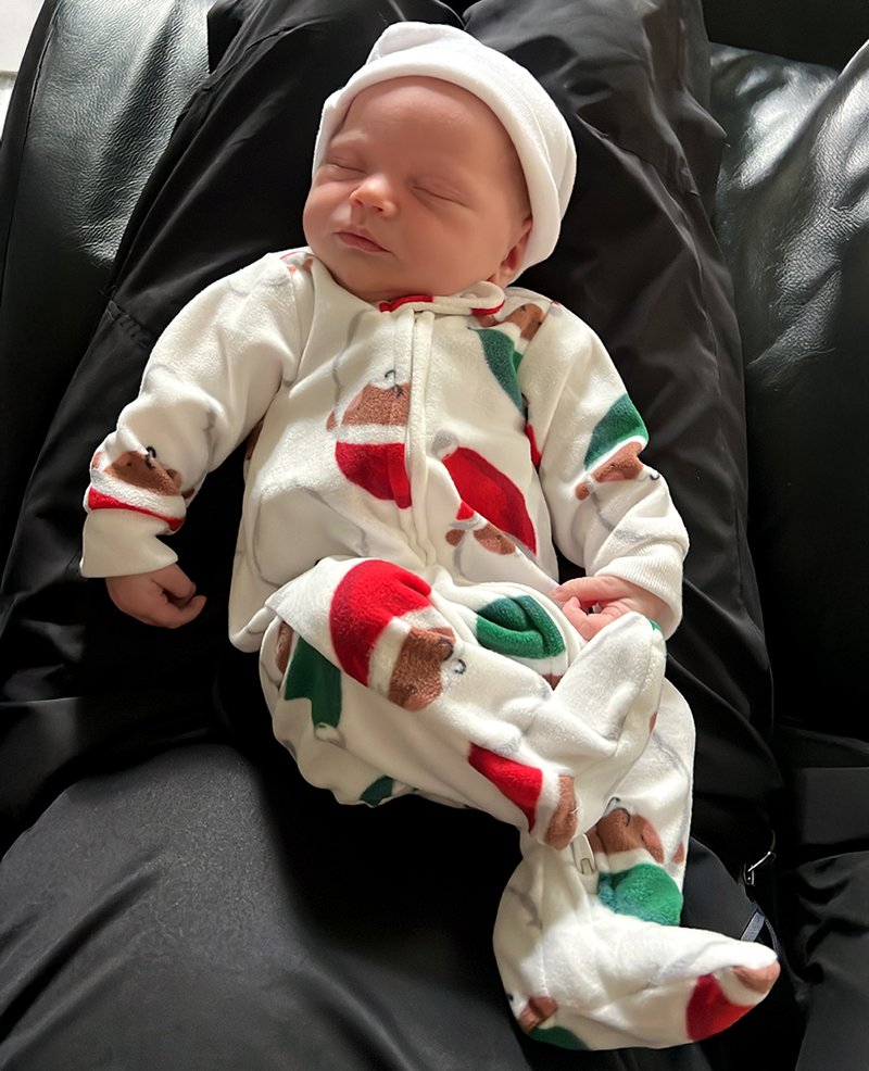 Baby Riley, a couple of days old, resting in my lap. 🥰